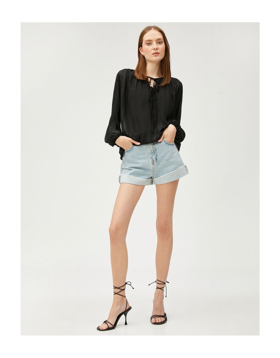 See-through blouse with lacing detail on the collar.